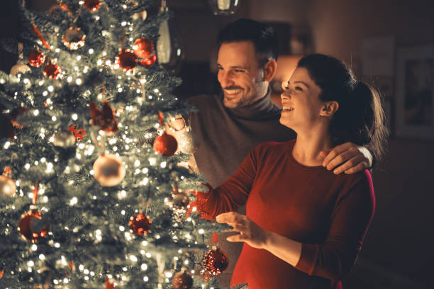 Christmas tree adorned with lighted ornaments and warm white lights.